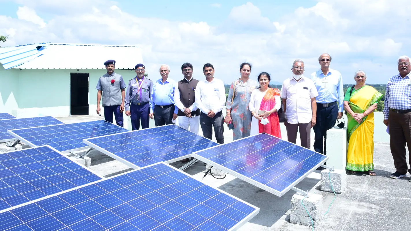 Rotarians on the new solar roof at Green Valley School, Kolar — a global grant project